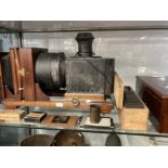 Victorian Magic Lantern projector complete with lens and containing an original lantern slide of the