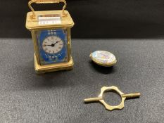 Halcyon Days brass cased miniature carriage clock, enamels with white enamelled dial, Roman