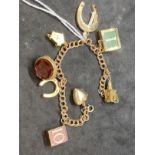 Hallmarked Jewellery: 9ct gold double trace link bracelet with eight assorted charms attached. Total