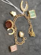 Hallmarked Jewellery: 9ct gold double trace link bracelet with eight assorted charms attached. Total