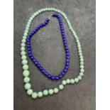 Jewellery: Jade necklace 22ins. Lapis lazuli necklace with a 14K clasp 16ins. (2)
