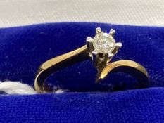 Jewellery: Yellow metal cross over set with a single brilliant cut diamond, estimated weight of 0.