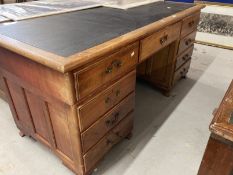 Edwardian mahogany stained nine drawer twin pedestal desk with brass drop handles. Approx. 66ins.