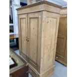 20th cent. Stripped pine Continental cupboard converted to wardrobe having two doors over two