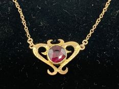 Jewellery: Art Nouveau ladies yellow metal pendant an 22ins chain, tests as 9ct gold. 2.7g.