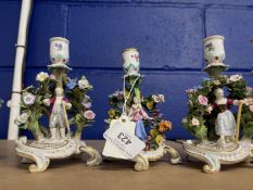 Late 19th cent. Meissen candlestick figures amidst a flowering bower in multicoloured enamel. 3