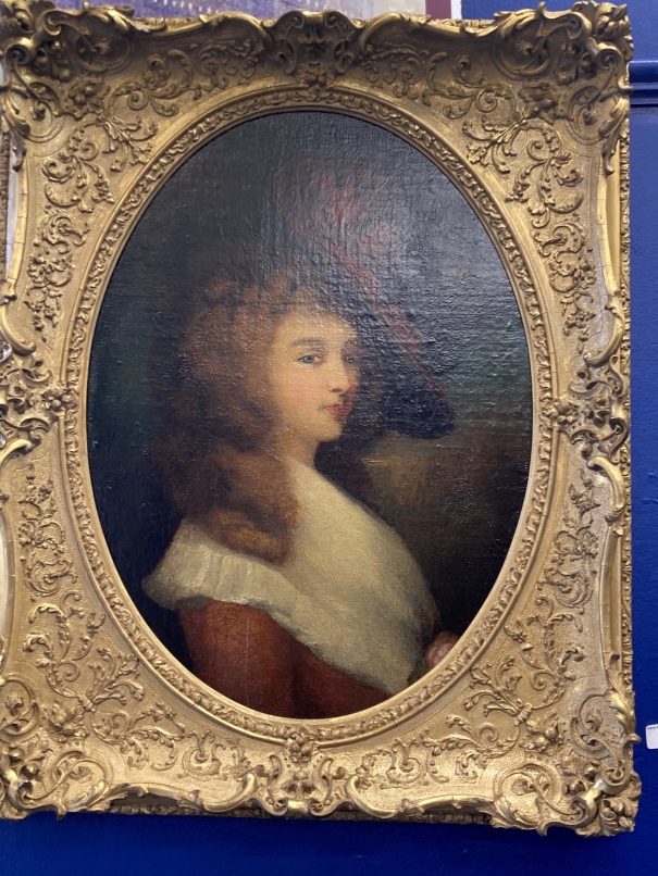 19th cent. English School: Oil on canvas head and shoulders portrait of a young woman wearing a