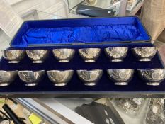 Hallmarked Silver: Set of twelve finger bowls inset with a George V coin to commemorate his