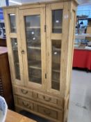 20th cent. Stripped pine display unit, two opening doors over two drawers. Approx. 67ins. x 35ins. x