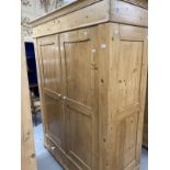 20th cent. Stripped pine Continental wardrobe having two doors over two drawers. Approx. 77ins. x
