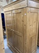 20th cent. Stripped pine Continental wardrobe having two doors over two drawers. Approx. 77ins. x