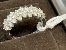 Jewellery: White metal three row half hoop ring set with twenty-eight brilliant cut diamonds,