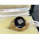 Jewellery: Yellow metal oval signet ring set with onyx and a rose cut diamond, tests as 18ct gold.