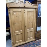 20th cent. Stripped pine Continental wardrobe with two doors. Approx. 77ins. x 49ins. x 21ins.