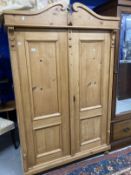 20th cent. Stripped pine Continental wardrobe with two doors. Approx. 77ins. x 49ins. x 21ins.