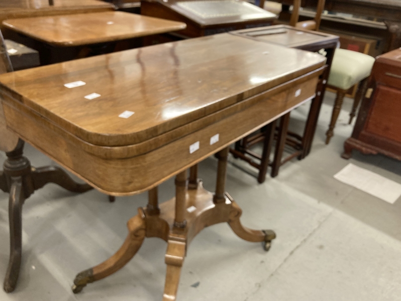 20th cent. Mahogany swivel top fold over card table, the four swept legs on brass castors supporting