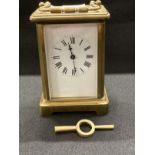 Clocks: French brass carriage clock, white enamel face, Roman numerals. 4½ins.