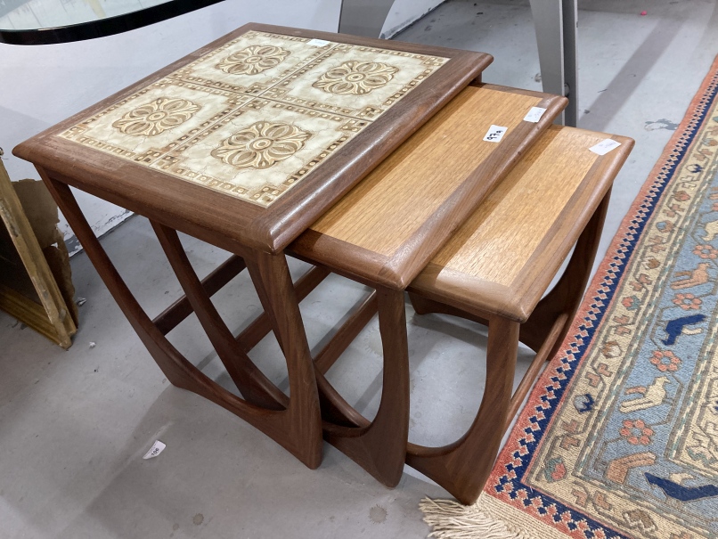 20th cent. G Plan nest of 3 tables, the largest table top inset with 4 brown and beige patterned