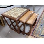 20th cent. G Plan nest of 3 tables, the largest table top inset with 4 brown and beige patterned
