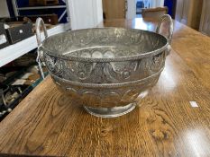 White metal Middle Eastern twin handle punch bowl with heavily embossed and engraved foliate band