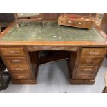 20th cent. Mahogany double pedestal desk, four drawers either side with carved handles, green