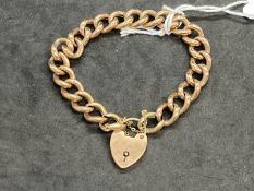 Hallmarked Jewellery: 9ct gold curb link bracelet with padlock fastener. Length 7ins. Weight 16.3g.