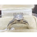 Jewellery: Diamond solitaire brilliant cut with two baguette cut shoulders. Platinum tested set,