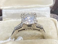 Jewellery: Diamond solitaire brilliant cut with two baguette cut shoulders. Platinum tested set,