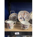 Pair of Derby teacups and saucers and one coffee can, painted with a Japanese Imari pattern c1820.