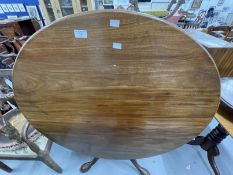 19th cent. Mahogany tilt top dining table on gun barrel supports, tripod club feet.