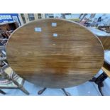 19th cent. Mahogany tilt top dining table on gun barrel supports, tripod club feet.