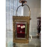 19th cent. Gilt brass pressed hanging lantern with red flash glass panelled windows. 16½ins.