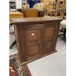 20th cent. Oak wall hanging cupboard of modest proportions, four panels to the two front doors and