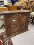 20th cent. Oak wall hanging cupboard of modest proportions, four panels to the two front doors and