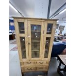 20th cent. Stripped pine display unit, two opening doors over two drawers. Approx. 67ins. x 35ins. x