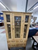 20th cent. Stripped pine display unit, two opening doors over two drawers. Approx. 67ins. x 35ins. x