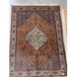 Rugs & Carpets: 20th cent. Middle Eastern carpet predominantly in red refreshed with ivory. 65ins. x
