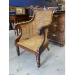 19th cent. Mahogany library chair with bergere back and seat, the latter requires attention.