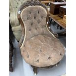 20th cent. Two nursing armchairs, one carved walnut on ceramic castors upholstered in brown, the