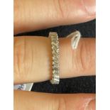 Jewellery: White metal eternity ring set with thirty two baguette cut diamonds, estimated weight