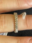 Jewellery: White metal eternity ring set with thirty two baguette cut diamonds, estimated weight