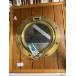 20th cent. Brass porthole mounted in an oak surround. 18ins.