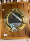 20th cent. Brass porthole mounted in an oak surround. 18ins.