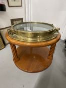 20th cent. Brass porthole mounted into a coffee table in the marine style. 22ins.