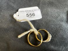 Hallmarked Jewellery: Two 18ct gold rings, one plain band, ring size Q. The other a three stone