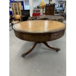 19th/20th cent. Mahogany drum table on column support terminating in brass claw feet and castors.