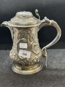 Silver & Plated Ware: George III white metal lidded jug with embossed floral decoration and having a