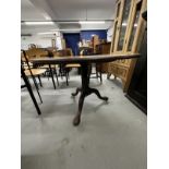 19th cent. Mahogany tilt top dining table on gun barrel supports, tripod club feet.