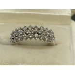 Jewellery: White metal three row half hoop ring set with twenty-eight brilliant cut diamonds,