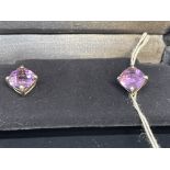 Jewellery: White metal pair of Tiffany earrings set with a square cut amethyst, tests as silver.